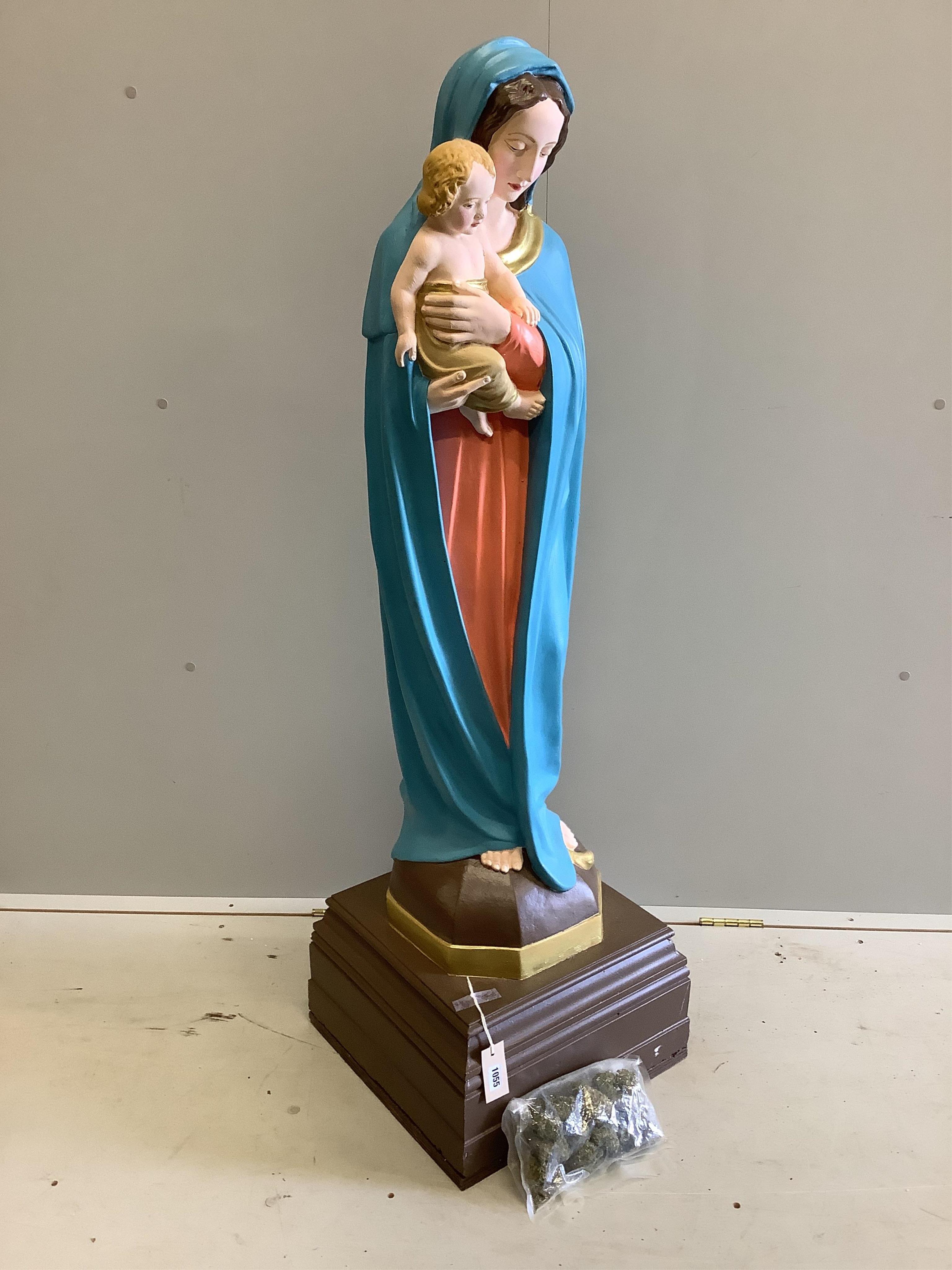 A large cast plaster Madonna and Child statue with a bag of fake marijuana. Provenance - used in Guy Richie's Netflix series 